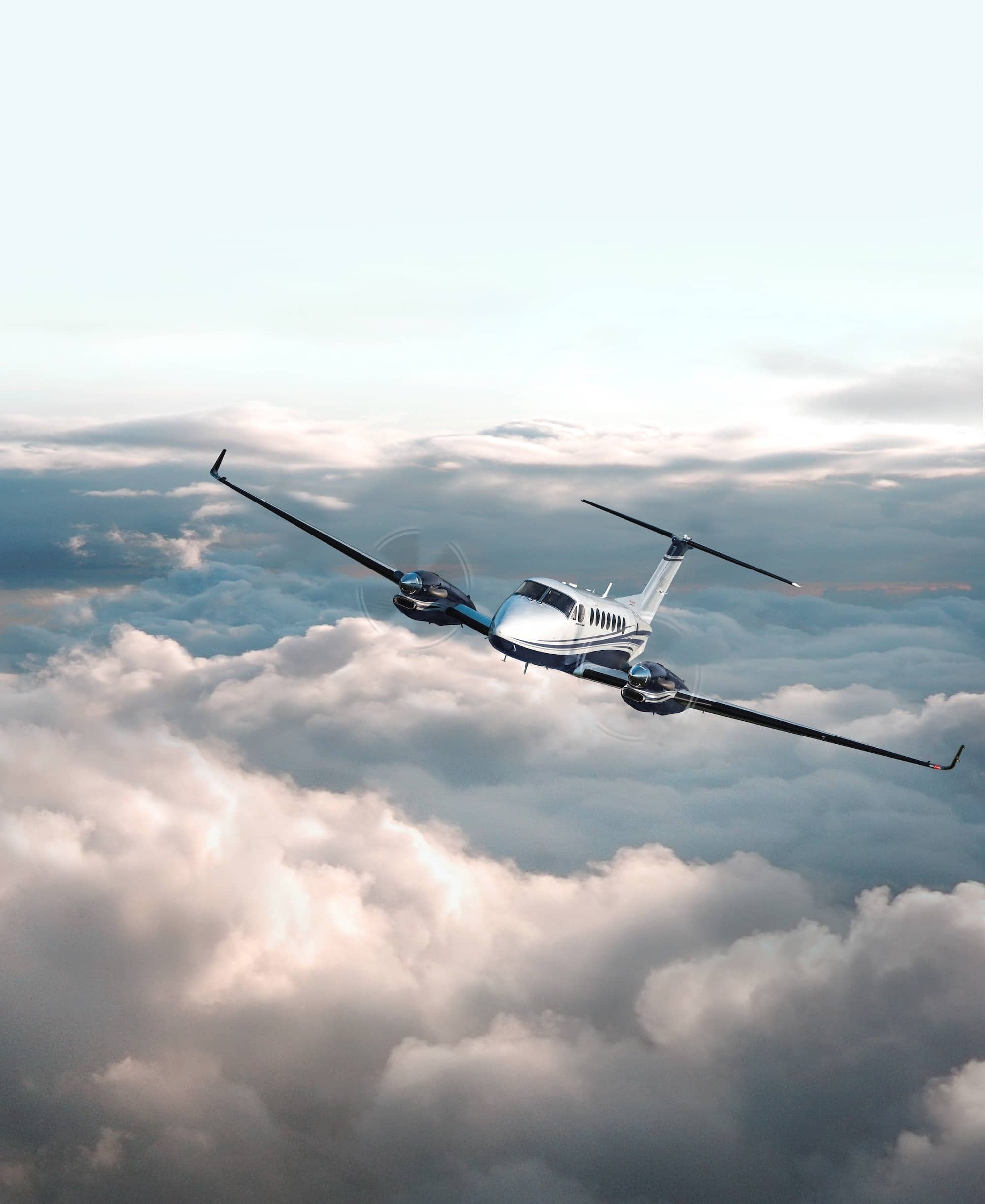 Beechcraft King Air 360 exterior flying through sky above clouds