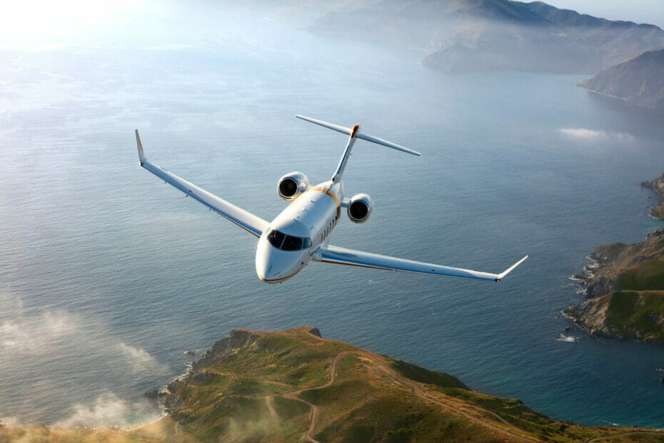 Bombardier Challenger 3500 Exterior cruising above water and mountains
