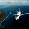Bombardier Challenger 650 Exterior aerial shot flying over sea and mountains