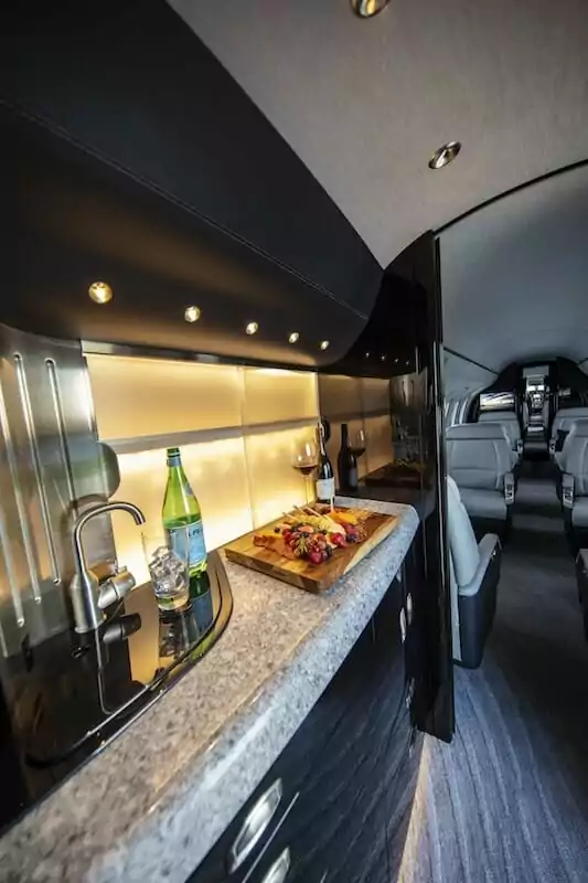 Cessna Citation Longitude Interior galley with water, sink, food and wine