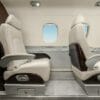 Embraer Phenom 300E interior seating white leather legroom