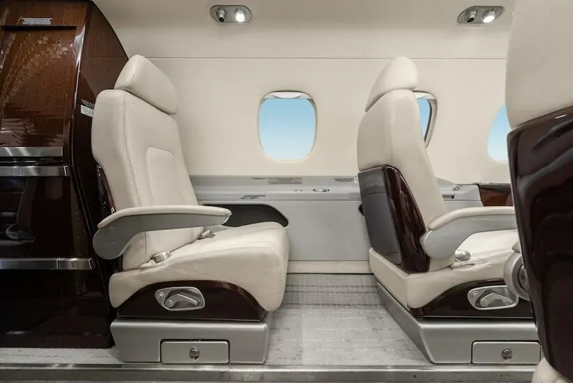 Embraer Phenom 300E interior seating white leather legroom