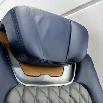 Embraer Phenom 300E close up shot of seat headrest blue leather