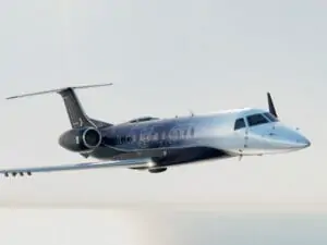 Embraer Legacy 650E Exterior at cruise with white cloud background