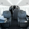 Embraer Legacy 650E Interior dark leather looking back through cabin