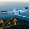 Gulfstream G800 exterior aerial shot cruising above mountains and water