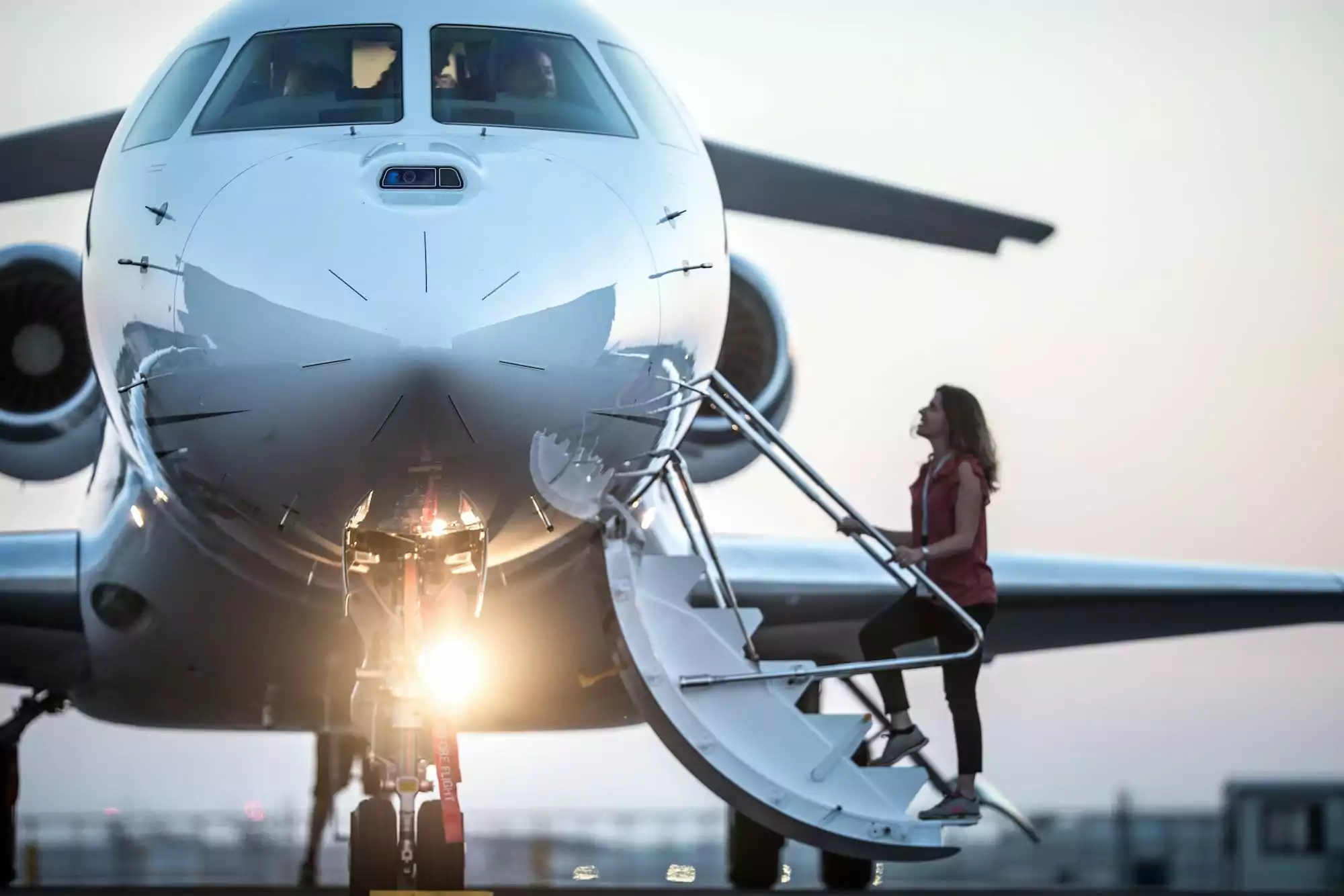 Dassault Falcon 8X with woman boarding - private jet from London to Duabi