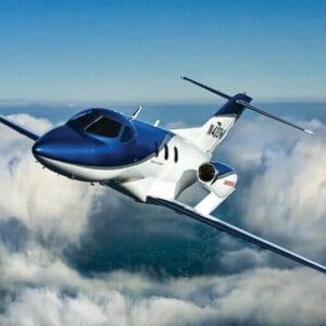 HondaJet Exterior in blue paint, aerial shot above the clouds banking left