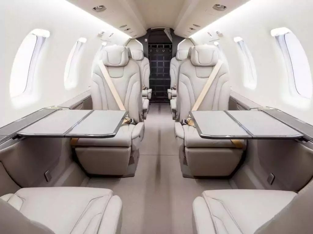 Pilatus PC-24 Interior with cream leather seats in upright mode and seatbelts fastened
