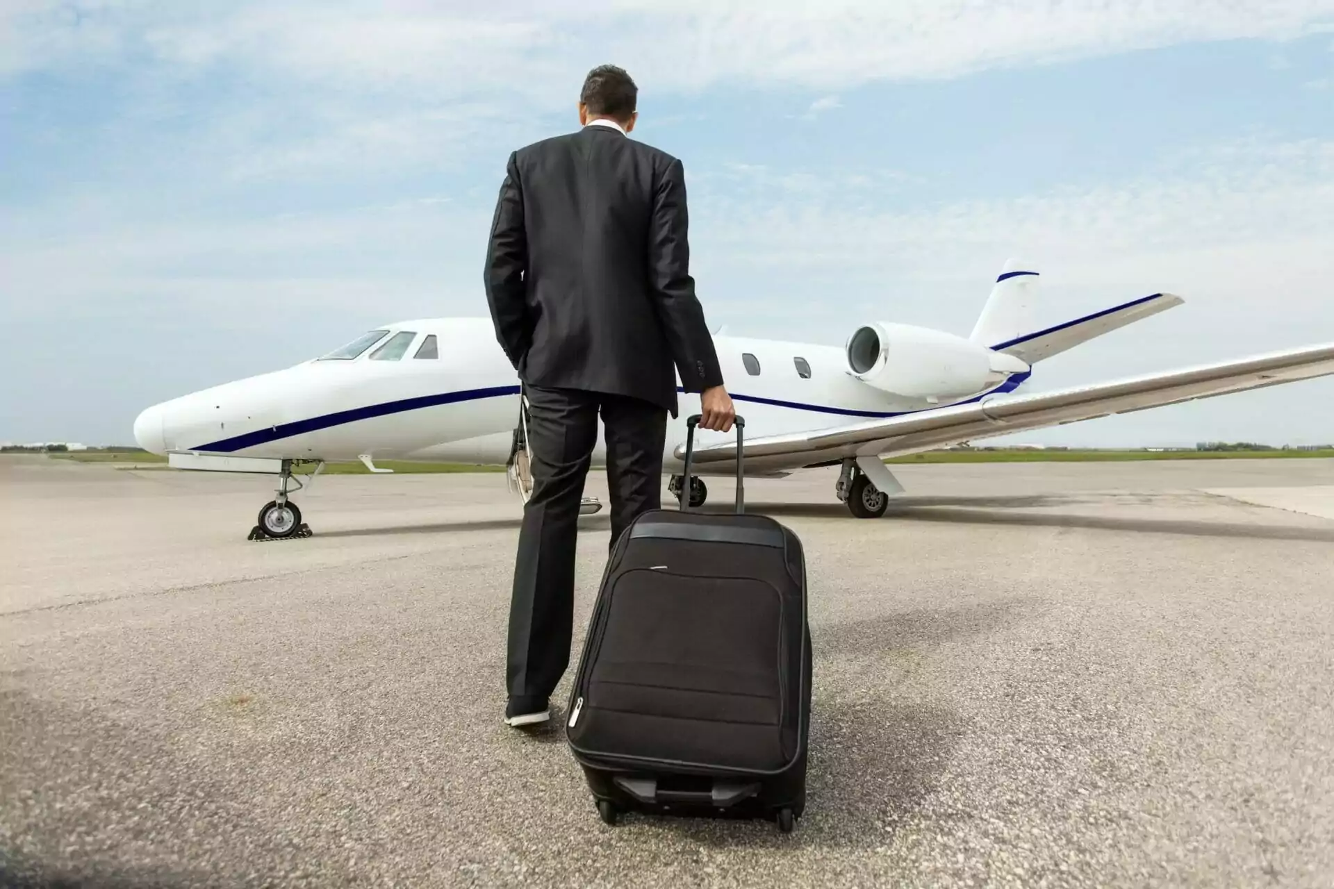 Businessman waiting to get on private jet ownership