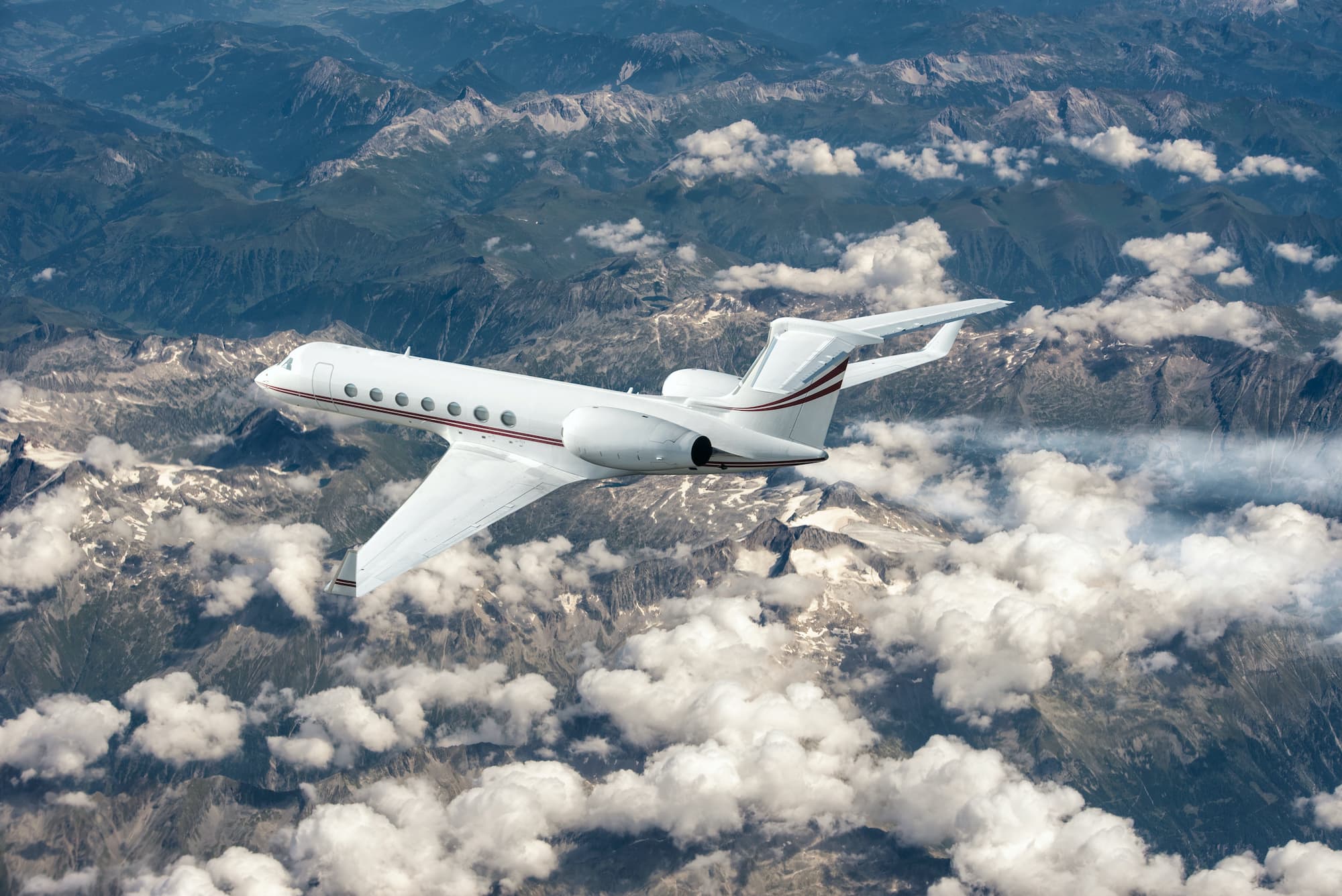 Business jet airplane flying on a high altitude above the clouds