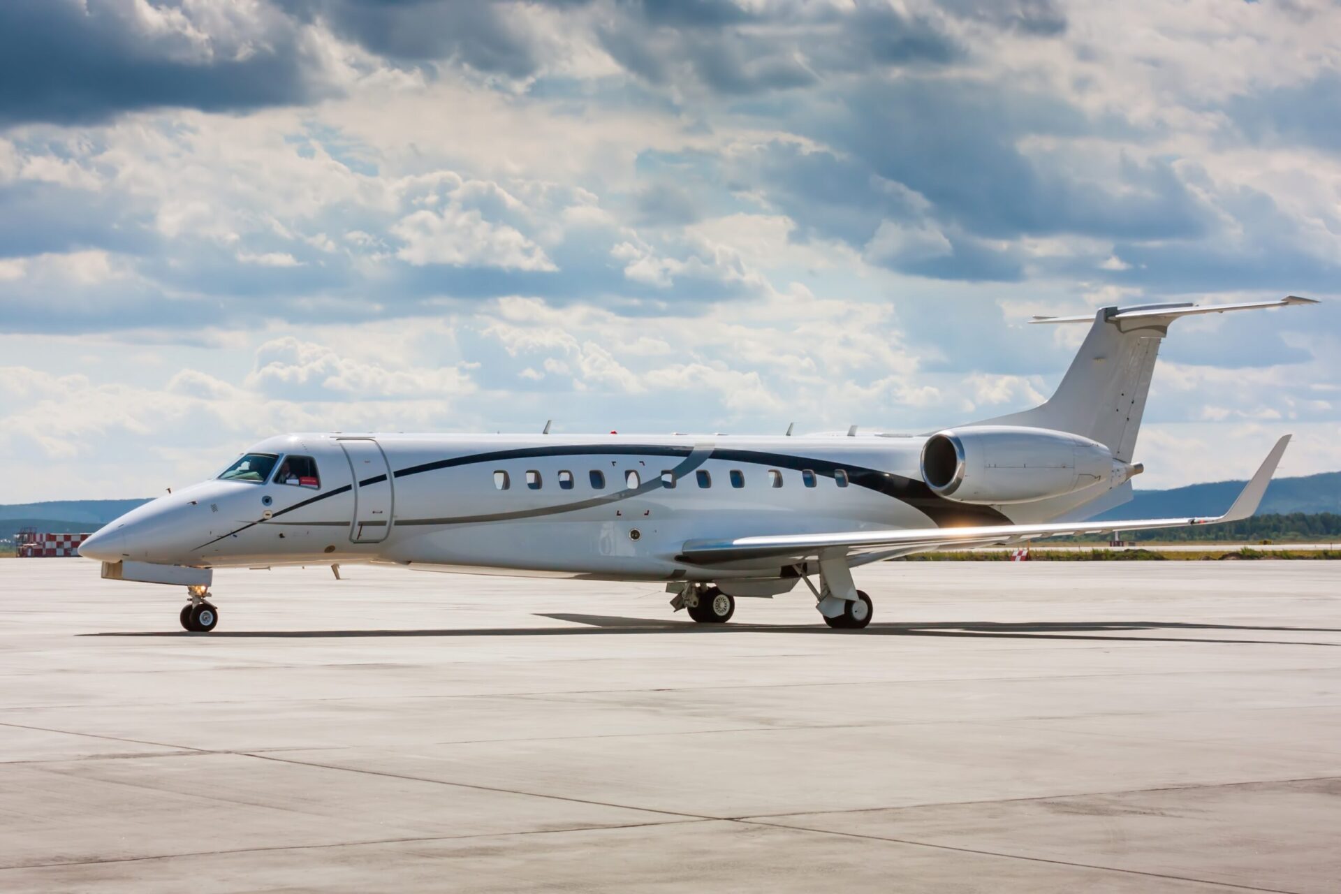 Embraer Legacy 650 parked on ramp at airport